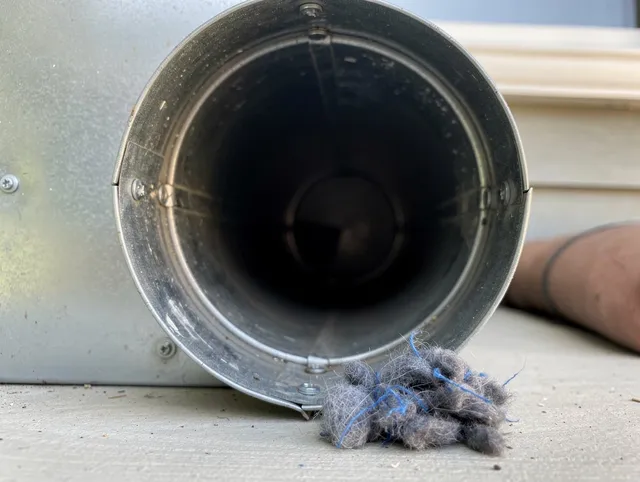 Willimantic Dryer Vent Cleaning technician using specialized equipment to clear severe dryer vent blockage in Willimantic